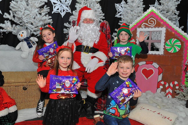 St Eithne’s Primary School P3 pupils Isabella, Caragh, Benjamin and Callum from Miss Gallagher’s class pictured with Santa during his visit on Friday. Photo: George Sweeney. DER2250GS – 48