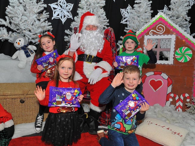 St Eithne’s Primary School P3 pupils Isabella, Caragh, Benjamin and Callum from Miss Gallagher’s class pictured with Santa during his visit on Friday. Photo: George Sweeney. DER2250GS – 48