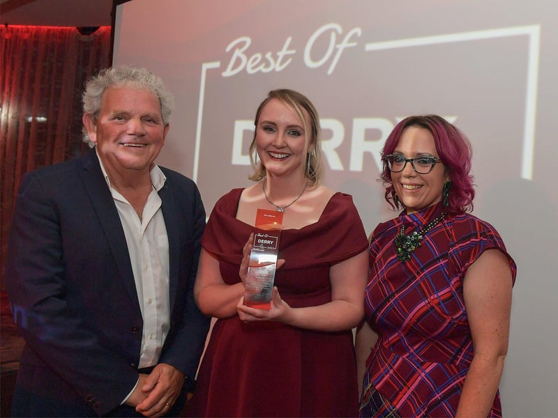 Business Person of the Year Award winner Charlene McCrossan, City Walking Tours, receives her trophy from Karina McKinney, Calor Custer Service Advisor, on the right, and compere Adrian Logan.  Photo: George Sweeney. DER2325GS – 51