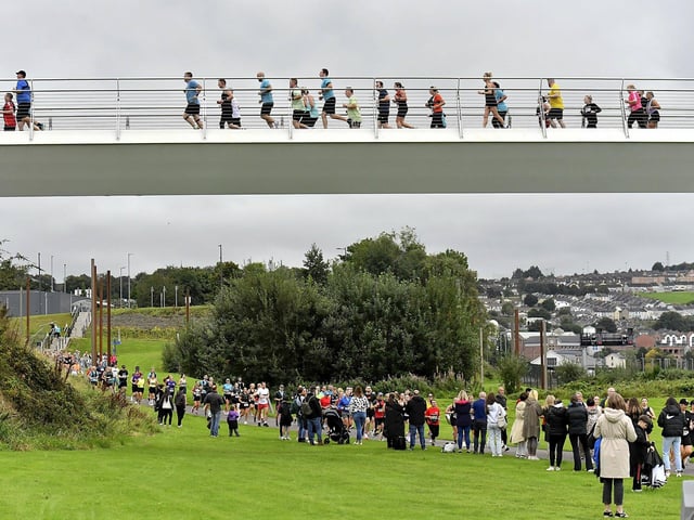 Competitors in the Waterside Half Marathon make their way over and under the Peace Bridge. Photo: George Sweeney
