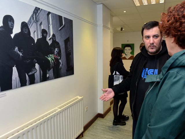 Artist Superbearderry chats with a guest at the launch of his exhibition ‘Injustice’ at the Eden Arts Centre on Monday evening last. The exhibition commemorating the 51st anniversary of Bloody Sunday runs until 1st February next.  Photo: George Sweeney. DER2305GS – 75