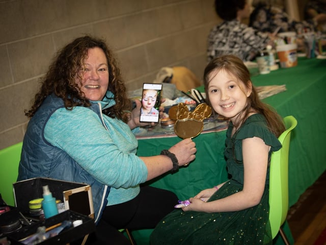 Face Painter Extraordinaire Annettie Spaghetti shows some designs to Rebecca Devine at Saturday's 'Christmas Get Together'. : .
