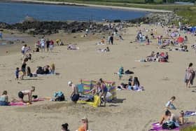 People gathered at Lady's Bay in Buncrana during a previous warm spell.