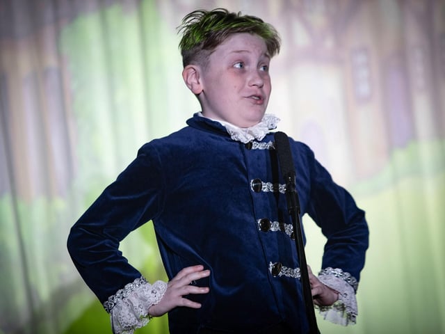 The energetic George McCarron as 'Buttons' on stage at Steelstown's PS production of 'Cinderella Rockerfella.'