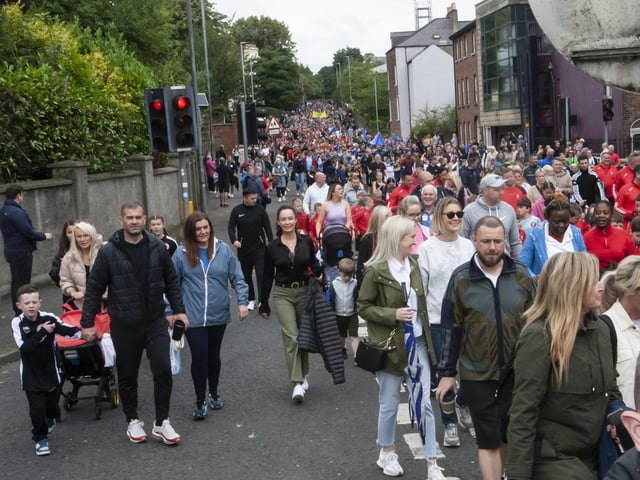 On the march . . . Teams, parents and coaches pictured during the parade through the city on Tuesday.