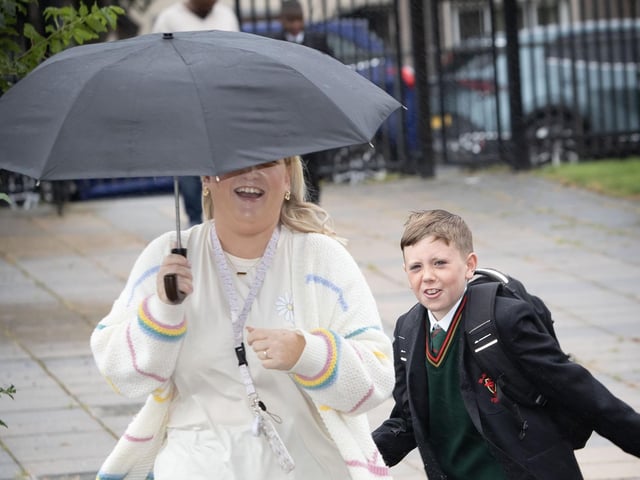 One of the new starts at St. Joseph's on Friday morning trying to avoid the camera, as is his mum!