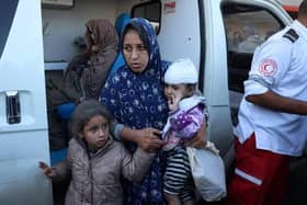Palestinian women and children injured in an Israeli strike, wait in an ambulance in front of the al-Aqsa Martyrs Hospital in Deir Al-Balah in the central Gaza Strip on November 17, 2024, amid the ongoing war between Israel and the Palestinian Hamas militant group. (Photo by BASHAR TALEB / AFP) (Photo by BASHAR TALEB/AFP via Getty Images)