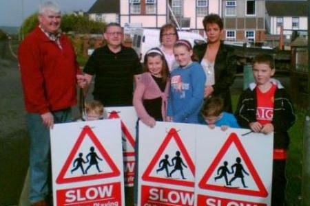 Residents of Oakbridge pictured with local Sinn Féin councillor Tony Hassan erecting signs in the area.