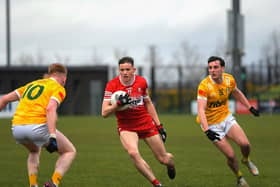 Antrim pair Conniaodh McCann and Callum Walsh close in on Derry’s Ruairi Forbes. Photo: George Sweeney