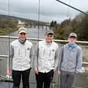 The three local anglers who have qualified to represent Ireland at the World Fly Tying Championships in Idaho, USA, from left Jacob Griffin, Zack Barnett and Lewis Porter standing on the River Mourne where the North West Angling Fair will take place this weekend.