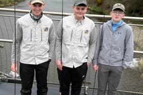 The three local anglers who have qualified to represent Ireland at the World Fly Tying Championships in Idaho, USA, from left Jacob Griffin, Zack Barnett and Lewis Porter standing on the River Mourne where the North West Angling Fair will take place this weekend.