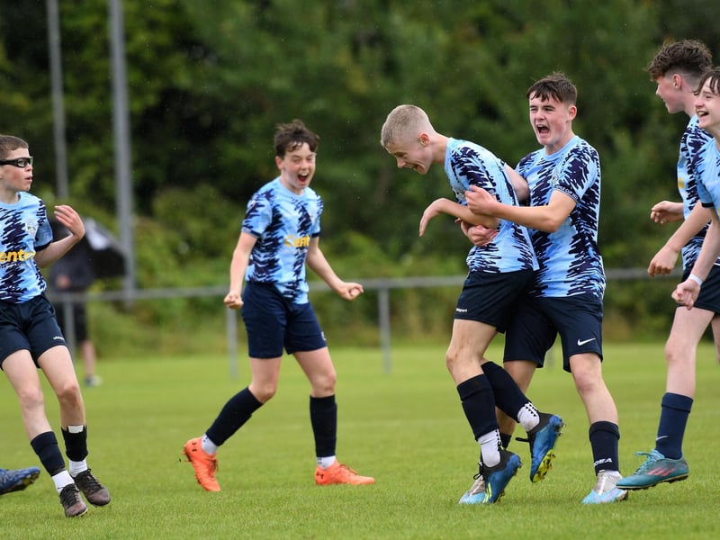 Magherafelt Sky Blues striker Fearghal McLarnon is mobbed by team-mates after scoring the opening goal of their O'Neills Foyle Cup Under-13's final against Maiden City Academy.