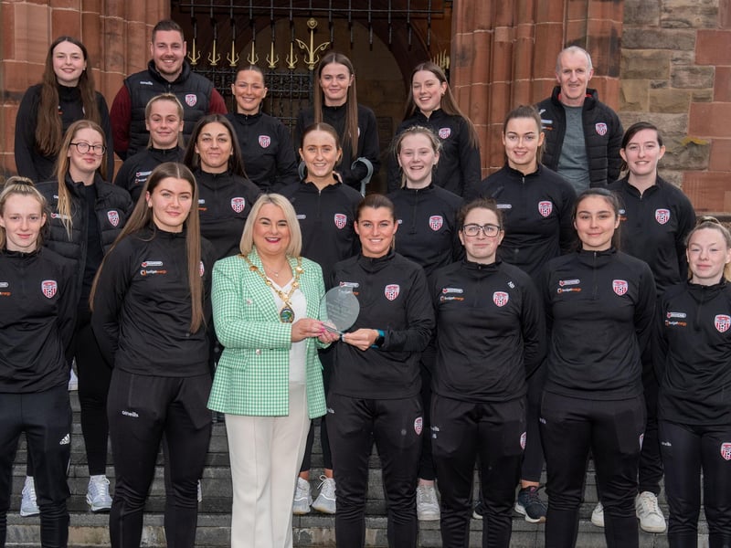 The Mayor Councillor Sandra Duffy pictured with Derry City Ladies Football team as she hosted a reception to mark their 20th anniversary. During the event the First Citizen presented a commemorative gift to captain, Shannon Dunne. The team were joined by coach Paul Dixon and Chairperson John Hegarty. Picture Martin McKeown. 05.05.23