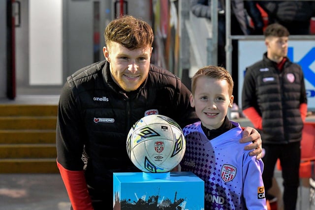 A young fan has his picture taken with Cameron McJannett before Derry City’s game against Cork City on Friday evening. Photo: George Sweeney. DER2308GS – 141