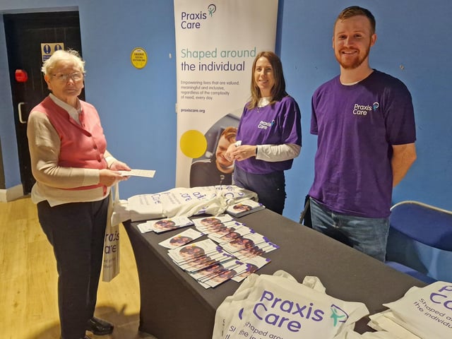 Helen Bradley from Glenbrook House learns more about Praxis Care, one of the organisations with an information stand at the event