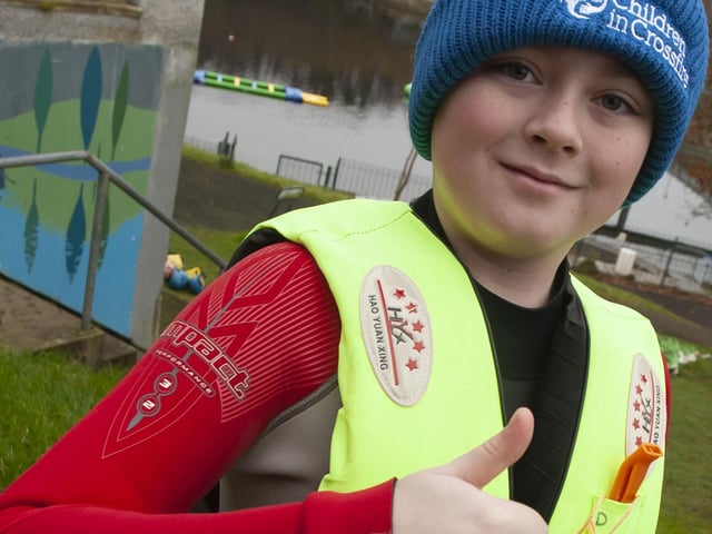 One of the young St. Joseph’s students gives the thumbs up before his pier jump on Saturday.