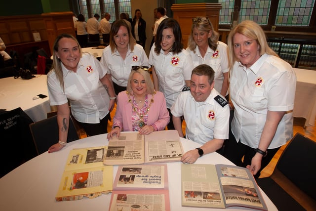 30 YEARS OF MEMORIES. . . . .Mayor Sandra Duffy and Stephen Twells, Foyle Search and Rescue look over some of the scrapbook memories of thirty years of service to the community in the city and district during Wednesday’s function in the Guildhall. Included at back from left, Fiona McDaid, Aisling McHugh, Sophie Dechant, Olivia McElhinney and Aisling Wallace.