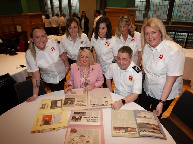 30 YEARS OF MEMORIES. . . . .Mayor Sandra Duffy and Stephen Twells, Foyle Search and Rescue look over some of the scrapbook memories of thirty years of service to the community in the city and district during Wednesday’s function in the Guildhall. Included at back from left, Fiona McDaid, Aisling McHugh, Sophie Dechant, Olivia McElhinney and Aisling Wallace.