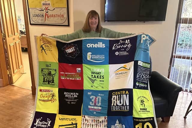 Cecilia holding one of the t shirt blankets which she is making and selling to raise funds that are going towards her marathon.