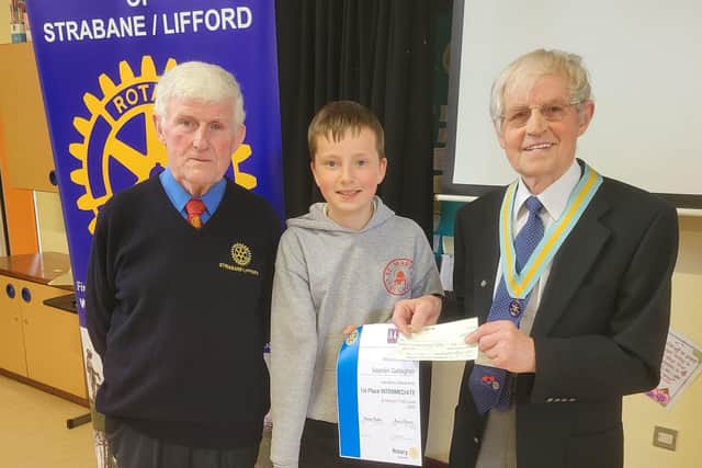 Dr. Morris Brown President of the Rotary Club of Strabane-Lifford presenting the awards to Seanán Gallagher, pupil of St. Mary’s Primary School, for his success in the Rotary Young Writer Competition.Also pictured is Rotarian John McCosker, Youth Services Officer for the local club.