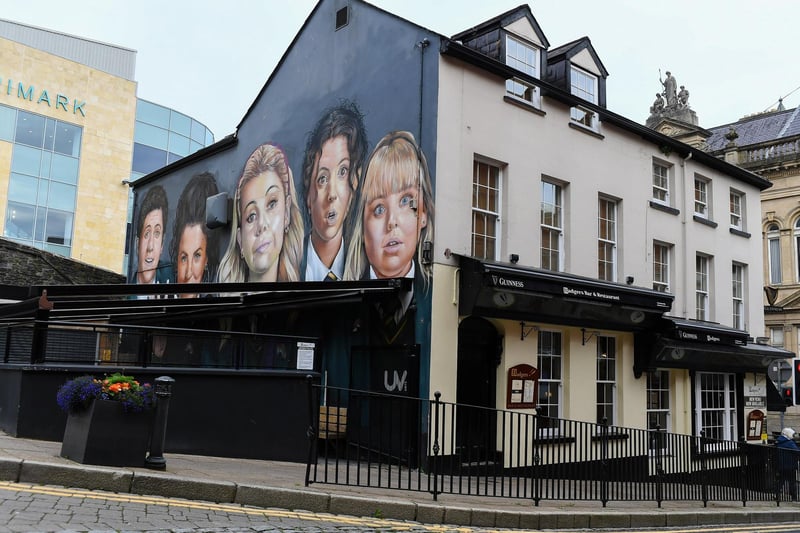 The Derry Girls Mural, on Orchard Street, with recently added pub awning. Photo: George Sweeney