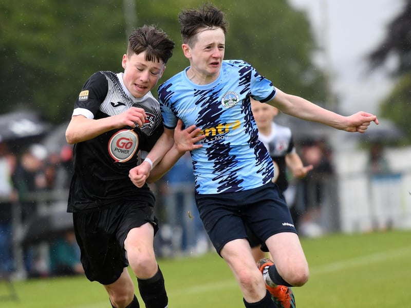 Magherafelt Sky Blues defender Rocco Devlin holds off Maiden City Academy forward Michael McColgan during their O'Neills Foyle Cup Under-13's final.