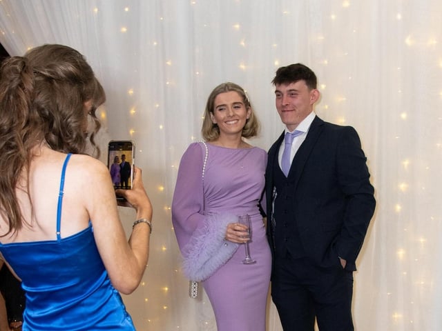 Dearbhla Harkin grabs a snap of Siorfra Harkin and Cahir McGroary at the Carndonagh Traders Association Business and Community Awards in Ballyliffen Lodge Hotel on Saturday night last. Photo Clive Wasson
