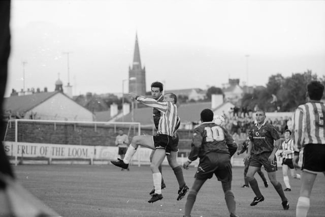 Derry's Gregory Kearney challenges Chelsea's Steve Clarke in the air.