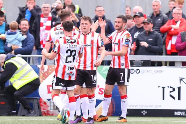 Michael Duffy celebrates his opening goal against Waterford with his Derry City teammates. Photographs by Kevin Moore.