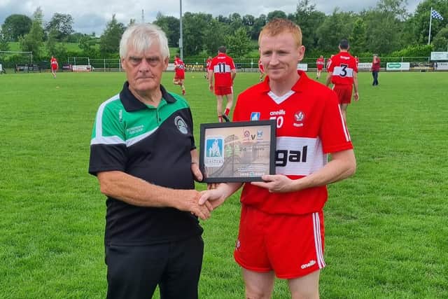 Derry Masters captain Jimmy O'Connor is presented with a plaque by Loup GAC.