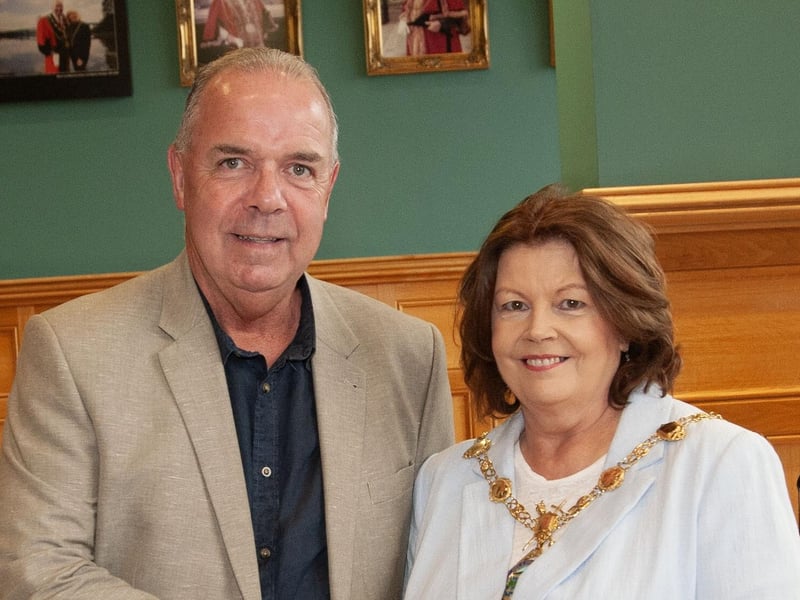 Retiring driver Andy McGillan receiving his award from the Mayor, Patricia Logue.