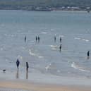 Dippers enjoy the sunshine and water at Lisfannon beach during a previous mini – heatwave. Photo: George Sweeney. DER2128GS – 047