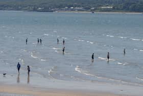 Dippers enjoy the sunshine and water at Lisfannon beach during a previous mini – heatwave. Photo: George Sweeney. DER2128GS – 047