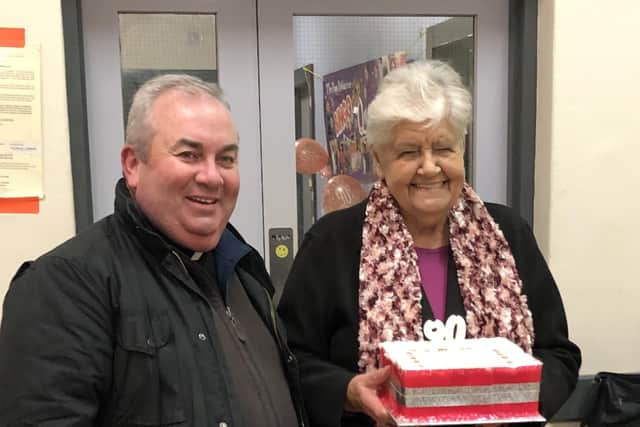 Fr. Francis Bradley drops into the Burt Bingo to join in Carmel Mc Dermott's 90th birthday celebrations.
