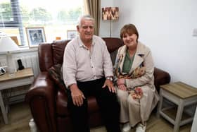 Content and cosy…Sharing the comforts of his new energy and cost efficient home in Lisnafin Park with Nicole Lappin, Chair of the Housing Executive is 86-year-old tenant John Gamble.