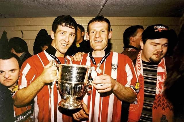 Paul Hegarty and Declan Boyle hold the league trophy in the Brandywell dressing room in 1997.
