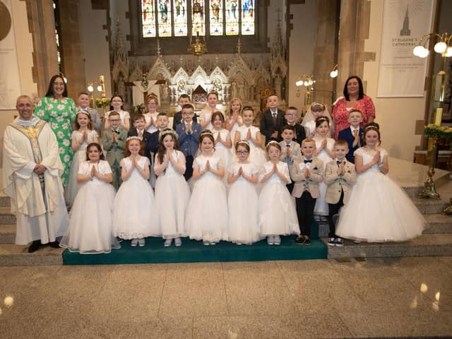Children from Rosemount Primary School who received the Sacrament of First Holy Communion from Fr. Paul Farren at St. Eugene's Cathedral on Friday last. Included are Mrs. Gallagher (teacher) and Miss Rooney. (Photos: Jim McCafferty Photography)