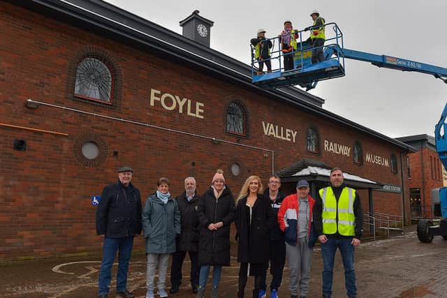 Mayor Sandra Duffy pictured with Destined ‘s Caroline O’Hara (in the Cherry Picker)at the unveiling the new replacement clock at the Foyle Valley Railway Museum on Wednesday afternoon.  Included in the photograph are Destined’s CEO Dermot O’Hara, Project Manager Charlene Keenan, Kevin Cregan of Foyle Builders and Destined members. The replacing of the clock was the final stage in the refurbishment works at the museum.  Photo: George Sweeney. DER2304GS – 21