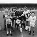 Captains Felix Healy and Steve Bruce shake hands ahead of the clash.