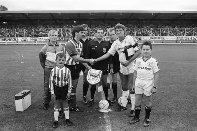Captains Felix Healy and Steve Bruce shake hands ahead of the clash.