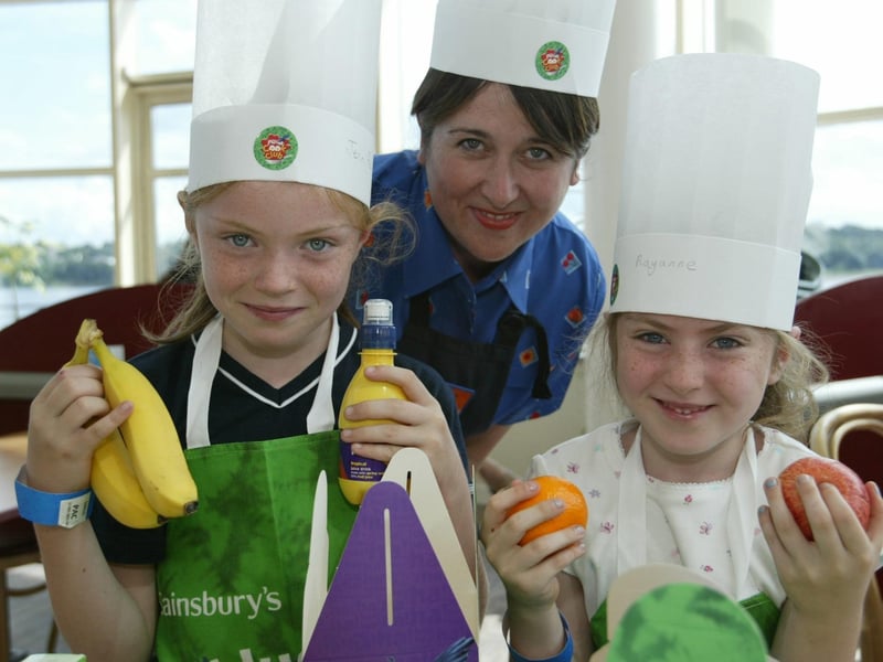 Sisters Jennifer and Rayanne O'Doherty with Julie Connolly, Food Advisor with Sainsbury's during the Cool Cook Club at the Strand Road store. (1508JB06) :Derry youngsters enjoying summer in August 2003