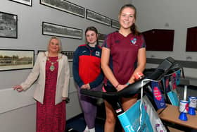 Student Katie McArthur, Lisneal College, and Megan Cairns, Foyle College, pictured with Mayor Sandra Duffy during  a break in their treadmill marathon in aid of Cancer Research UK, at the school on Wednesday morning. Photo: George Sweeney. DER2308GS – 95