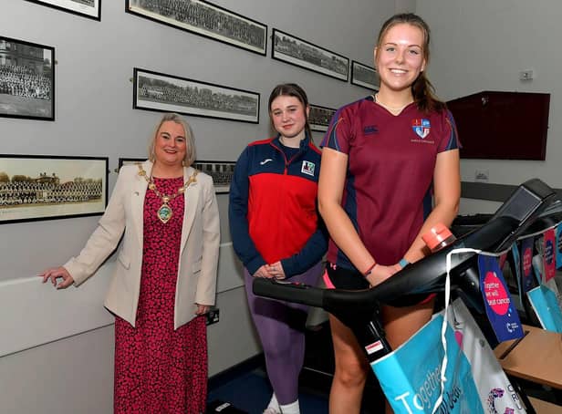 Student Katie McArthur, Lisneal College, and Megan Cairns, Foyle College, pictured with Mayor Sandra Duffy during  a break in their treadmill marathon in aid of Cancer Research UK, at the school on Wednesday morning. Photo: George Sweeney. DER2308GS – 95