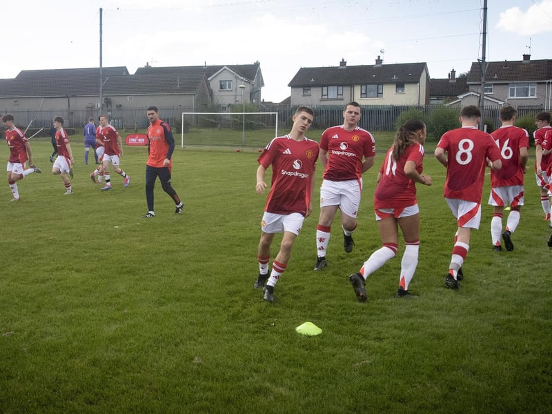 Man United Foundation BTEC students warming up before kick off under the guidance of coach Declan Lynch.