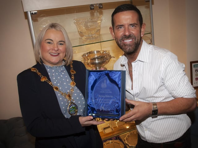 Well known local entertainer Micky Doherty pictured receiving a presentation from the Mayor, Sandra Duffy in recognition of his charity work in the city and district, at a reception in his honour on Thursday evening at the Guildhall. (Photo: Jim McCafferty Photography)