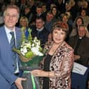 Doctor Tim Campbell presents singer Dana with a bunch of flowers thanking her for her presence at the launch of the new exhibition at the St Patrick Centre in Downpatrick.