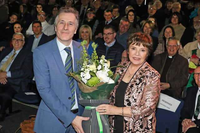 Doctor Tim Campbell presents singer Dana with a bunch of flowers thanking her for her presence at the launch of the new exhibition at the St Patrick Centre in Downpatrick.