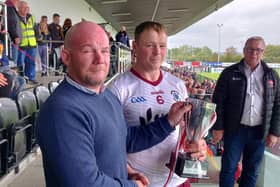 Ballinascreen captain Paul Cleary receives the Derry Intermediate trophy at Owenbeg on Sunday.
