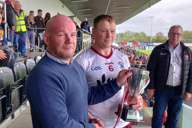 Ballinascreen captain Paul Cleary receives the Derry Intermediate trophy at Owenbeg on Sunday.