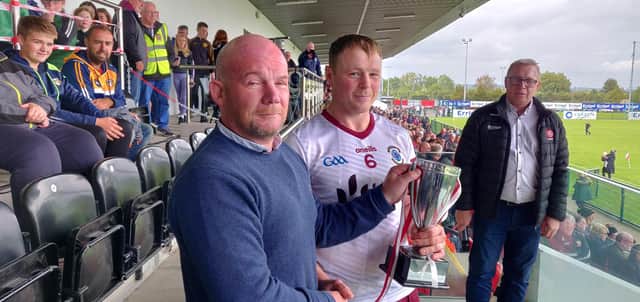 Ballinascreen captain Paul Cleary receives the Derry Intermediate trophy at Owenbeg on Sunday.